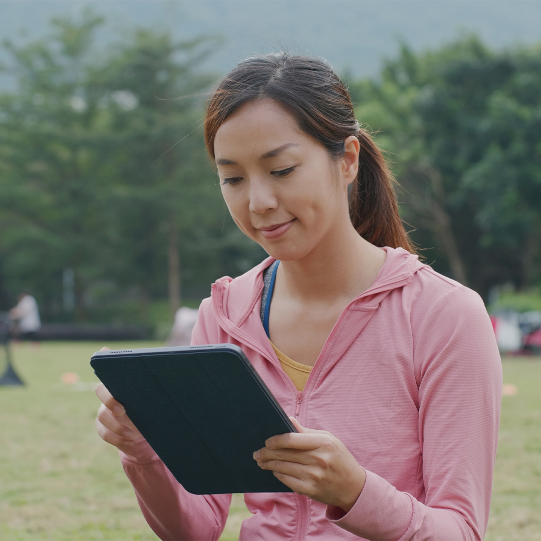 smiling-camp-counselor-soccer-field-tablet