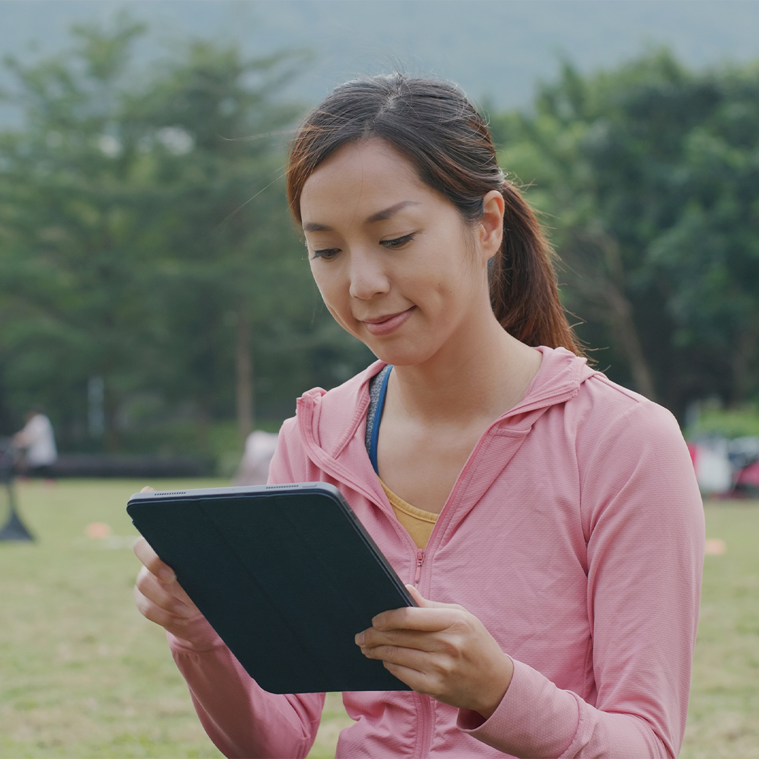 smiling-camp-counselor-soccer-field-tablet